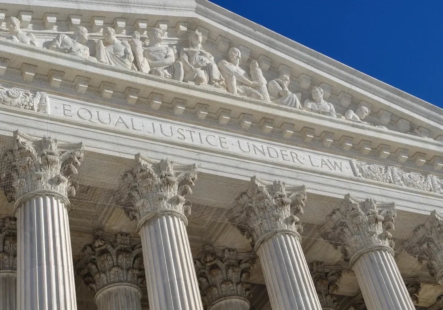 A close up of the front of a building with columns.