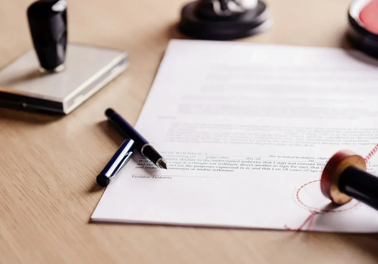 A pen and paper on top of a table.