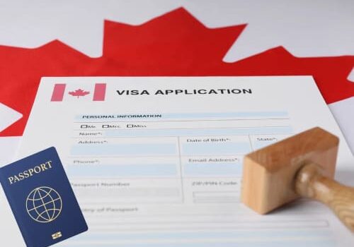 A canadian visa application form with a stamp and flag of canada in the background.